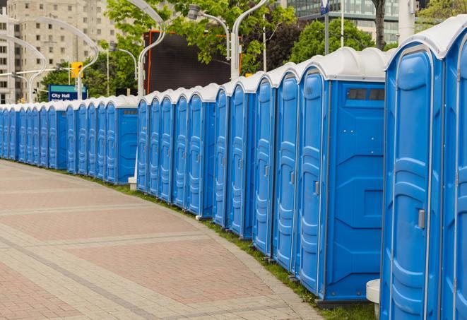 a row of portable restrooms at an outdoor special event, ready for use in Barataria, LA